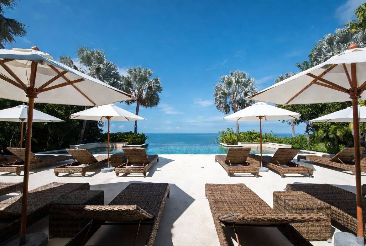 Hotel pool terrace with rattan loungers